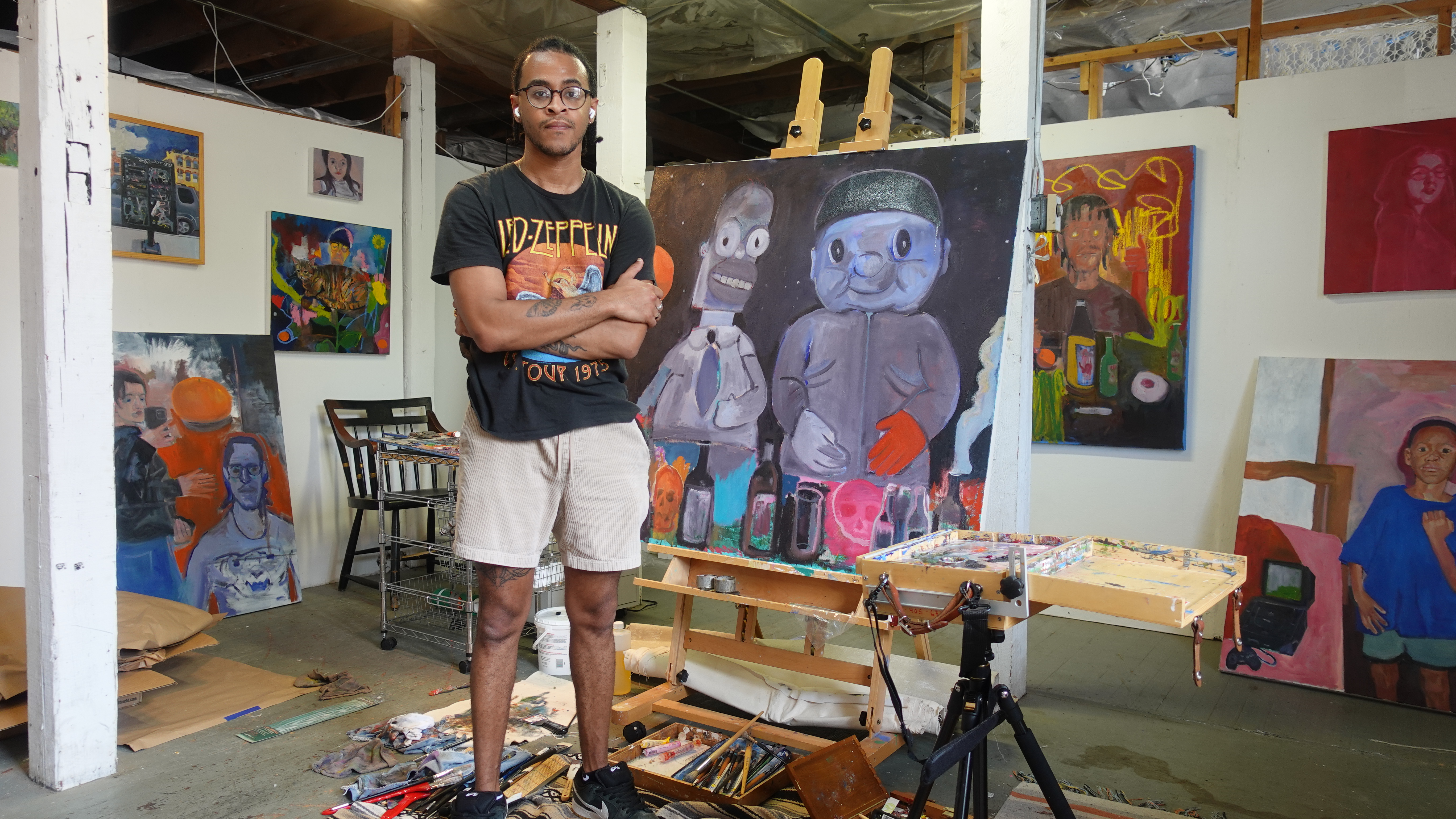 Jason Correia standing beside a painting in his studio
